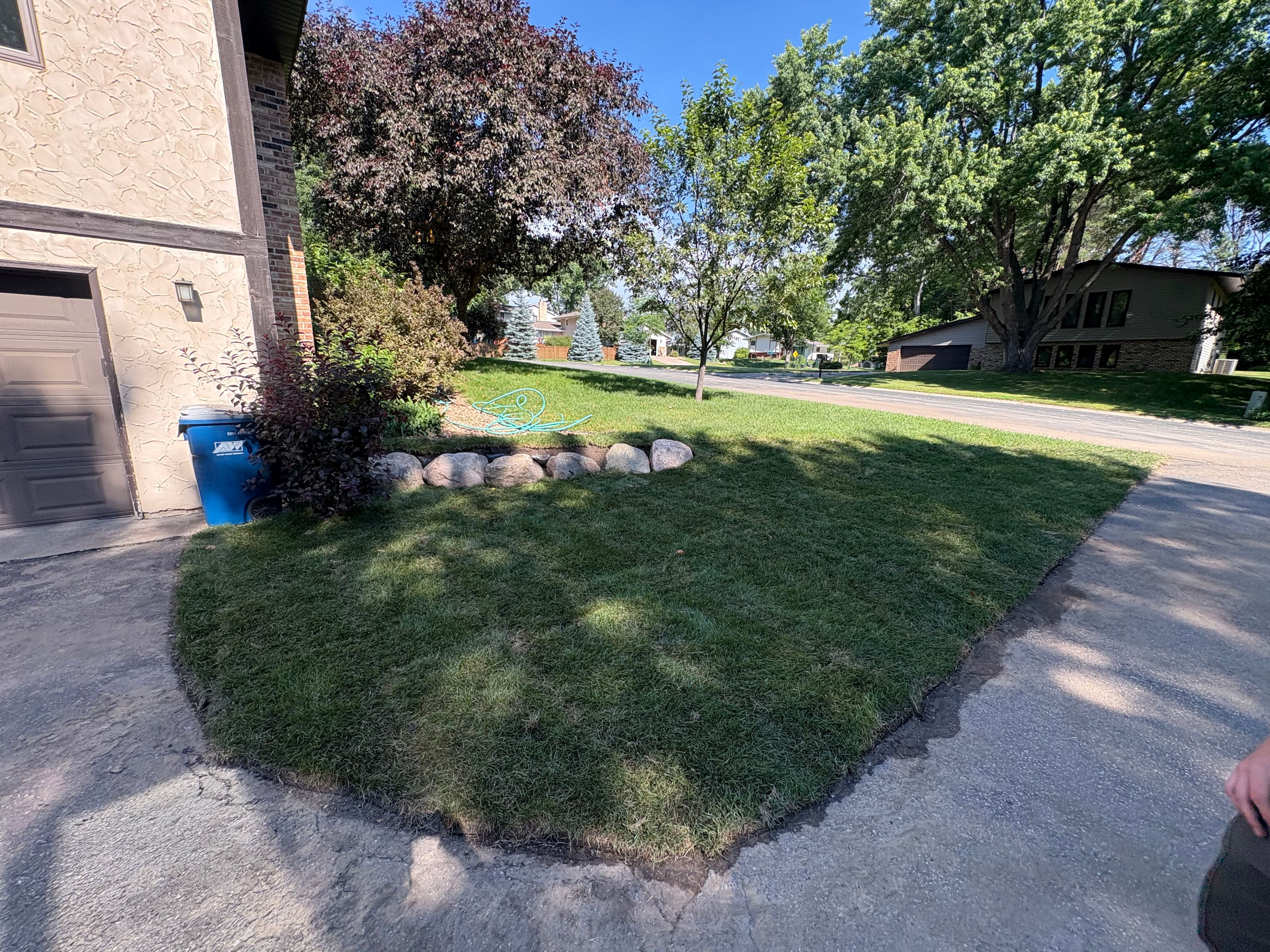 Project Fresh Sod and River Rock Give This Yard a Clean, Low-Maintenance Look image